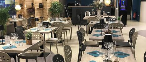 A restaurant with multiple tables set for dining, equipped with chairs, tables, and various table settings including plates, glasses, and cutlery.