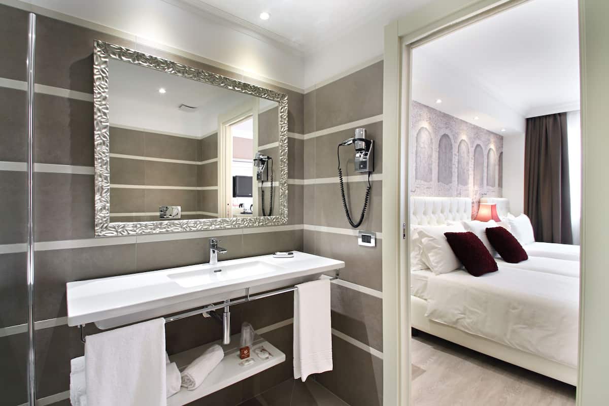 deluxe triple room | bathroom | hair dryer, bidet, towels