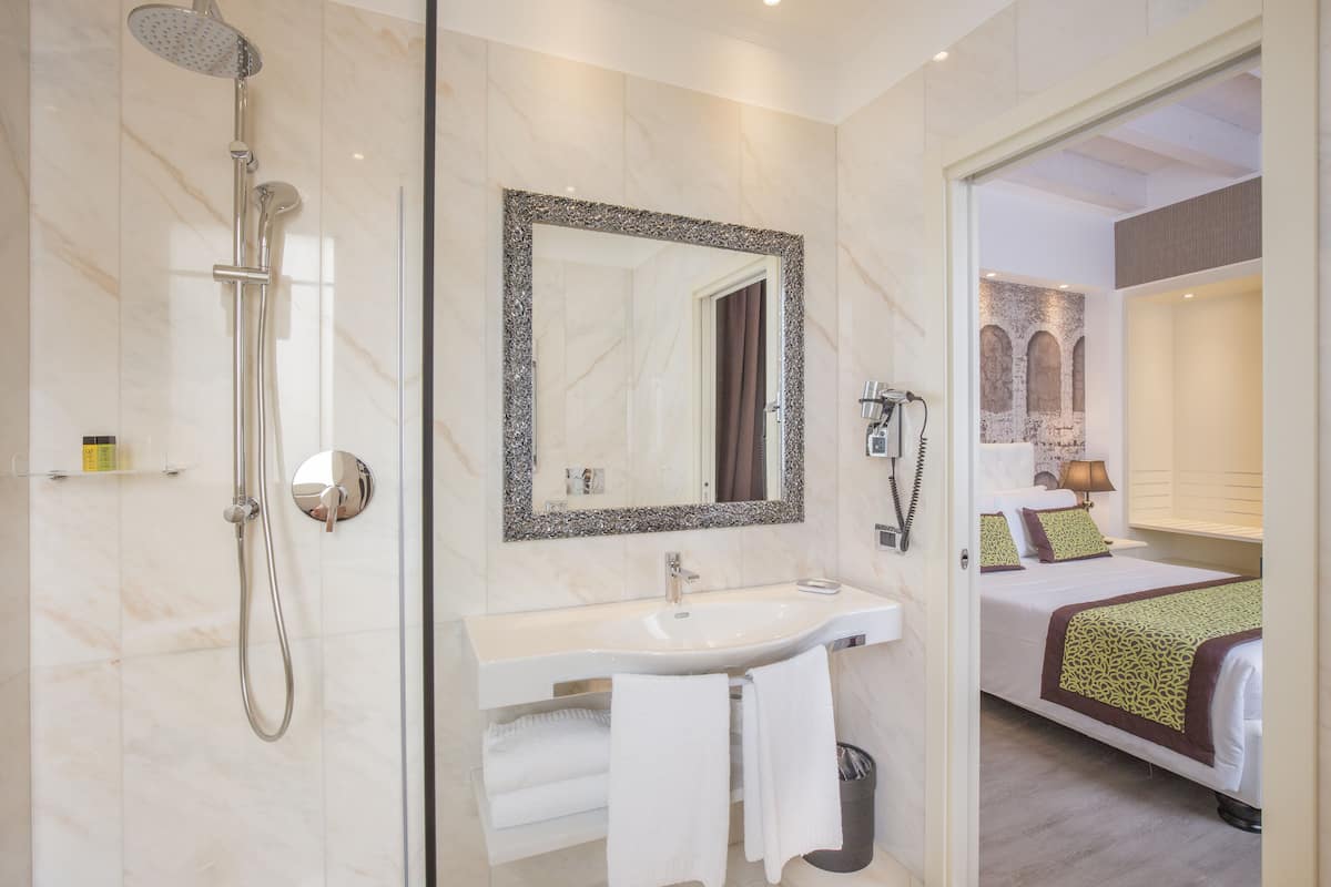 deluxe triple room | bathroom | hair dryer, bidet, towels