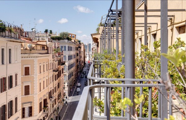 Stroll through historic streets lined with traditional architecture, flanked by balconies and lush greenery.