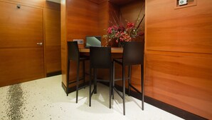 A wooden-paneled room with a desk, two chairs, and a laptop. - Hotel Memphis (Rome)