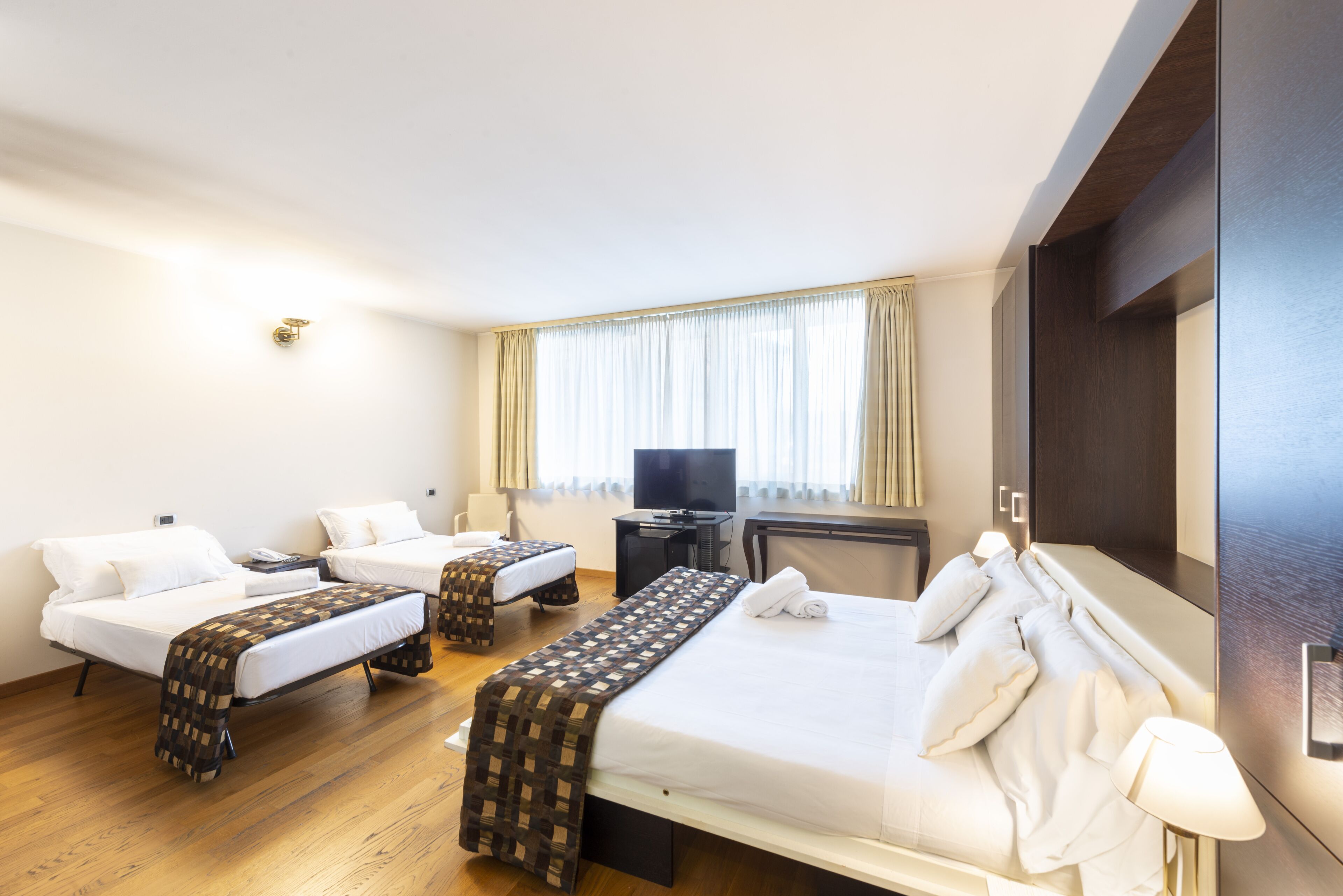 superior triple room | minibar, in-room safe, desk, blackout curtains