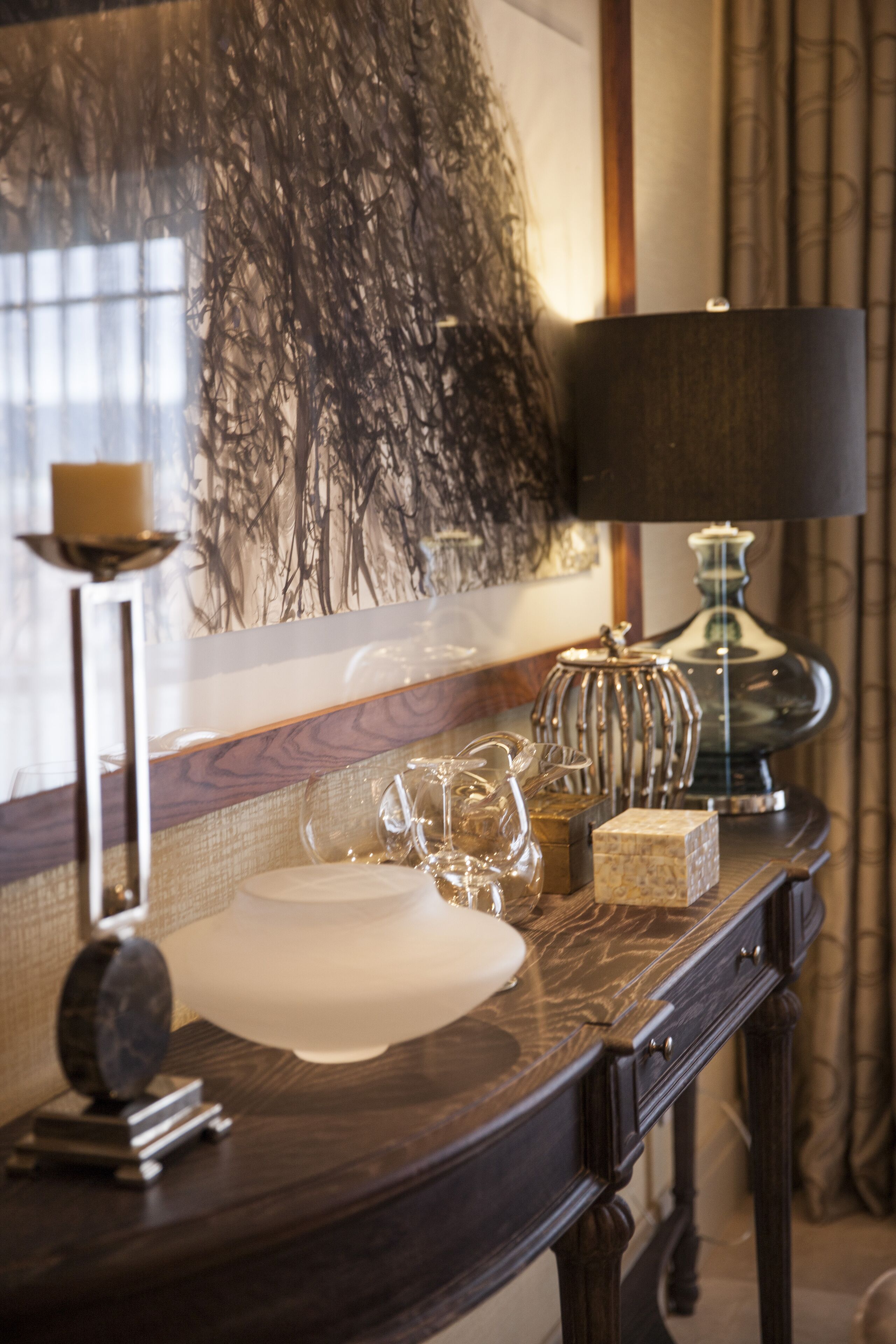 A bathroom vanity with a mirror, a sink, and various decorative items.