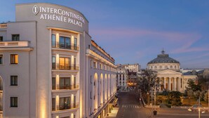 Intercontinental Athénée Palace hotel with a grand entrance, multiple floors, and a view of a historic building in the background. - InterContinental Athénée Palace Bucharest by IHG (Bucharest)