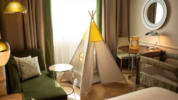 Relax in this inviting space with a comfortable sofa, armchair, and plush bed, complemented by a unique teepee tent.