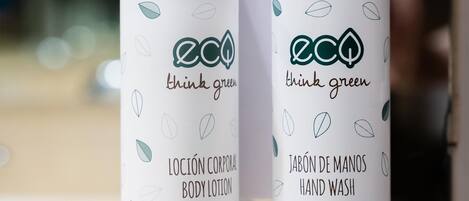 Two bottles of body lotion and hand wash with leaf patterns and the text "think green".