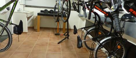 A bicycle storage area with multiple bikes parked and secured.