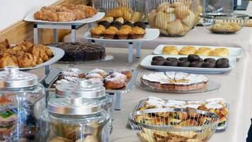 Un bufé con diversos pasteles y postres.