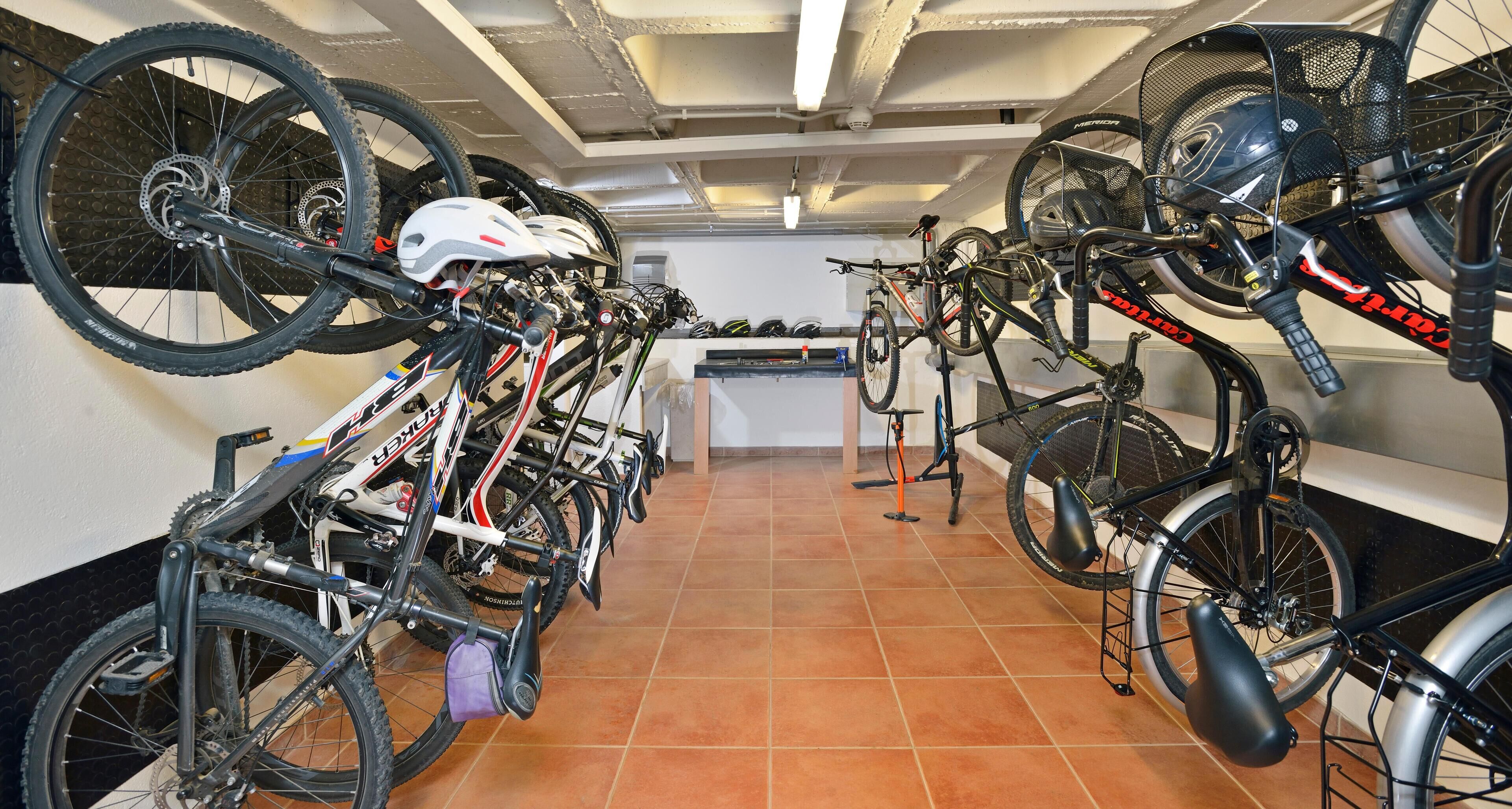 A bike storage area with multiple bicycles secured on racks.