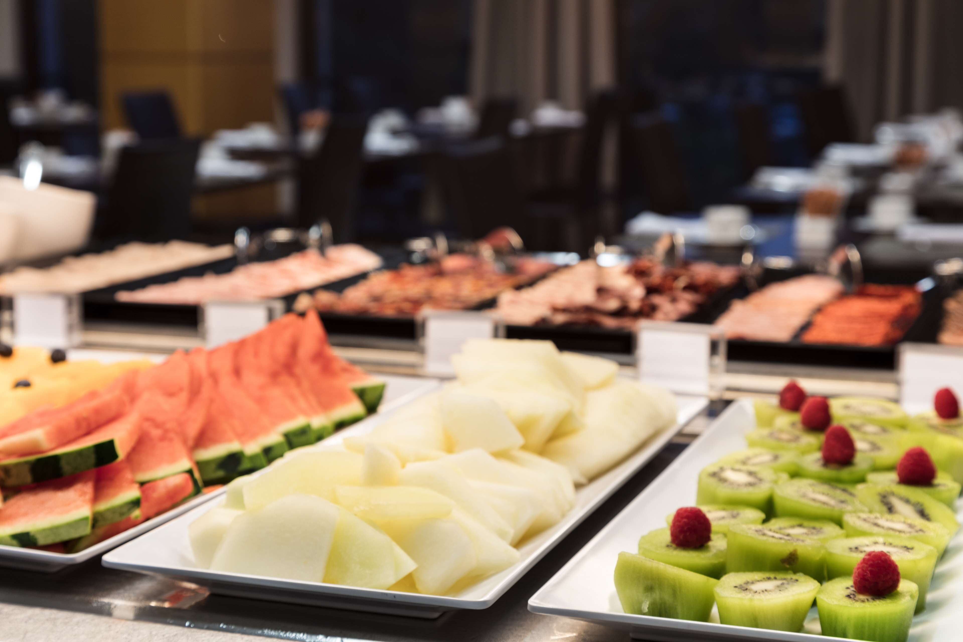 A buffet with various fruits and vegetables.