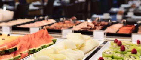 A buffet with various fruits and vegetables.