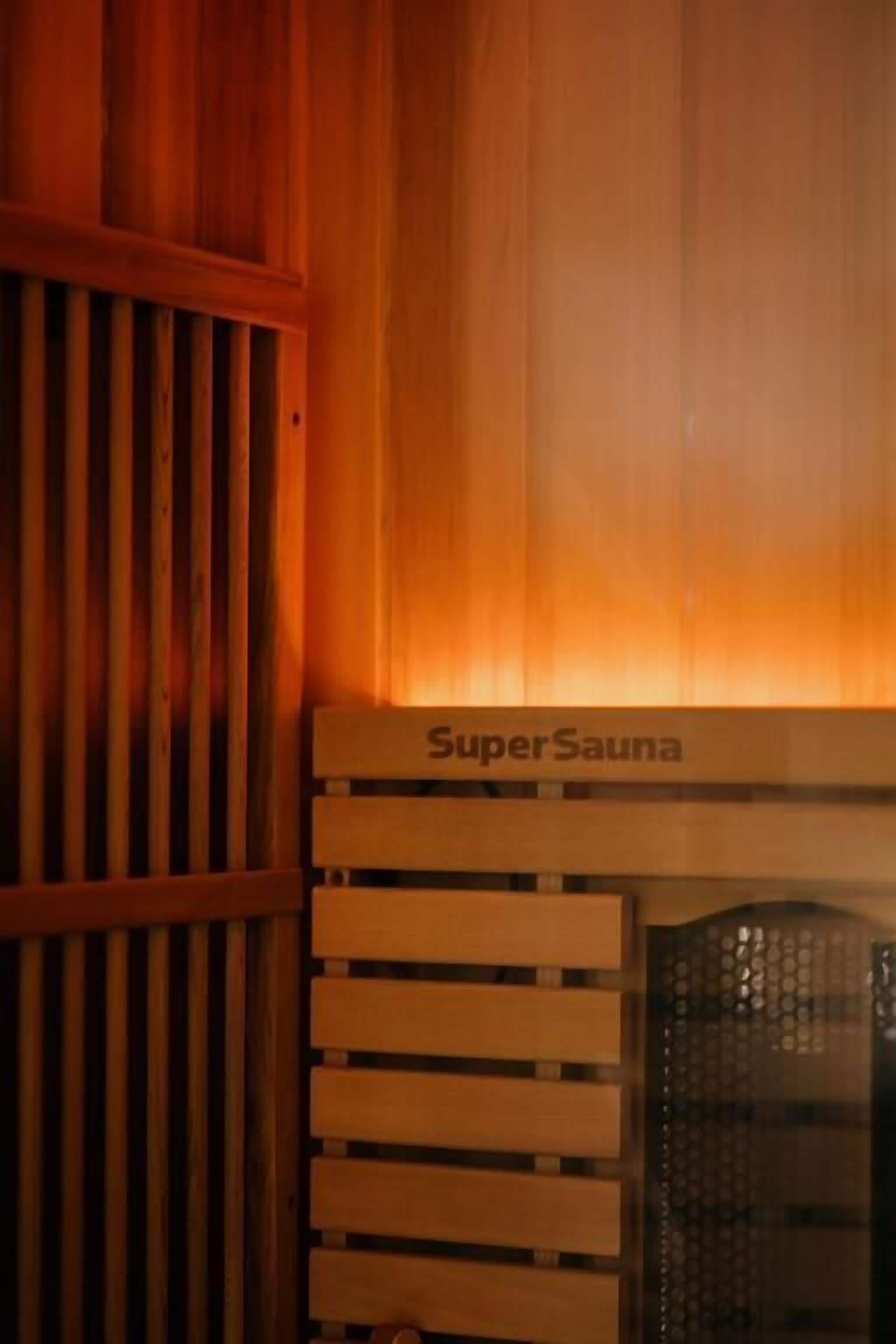 A wooden sauna with the label "SuperSauna" on the front panel.