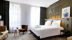 A hotel room with a bed, a chair, a small table, and a sofa. - Mercure Grand Hotel Metz Centre Cathédrale (Metz)