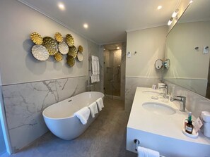 Separate bathtub and shower, deep-soaking bathtub, designer toiletries
