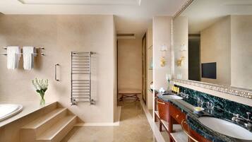 A bathroom with two sinks, a large mirror, and a towel rack.