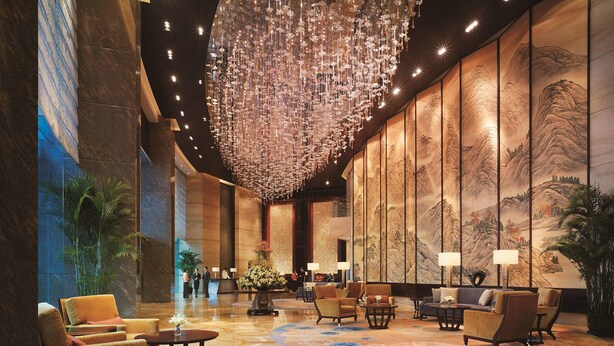 A lobby with a large chandelier, traditional artwork, and seating areas. - Shangri-La Qingdao (Qingdao)