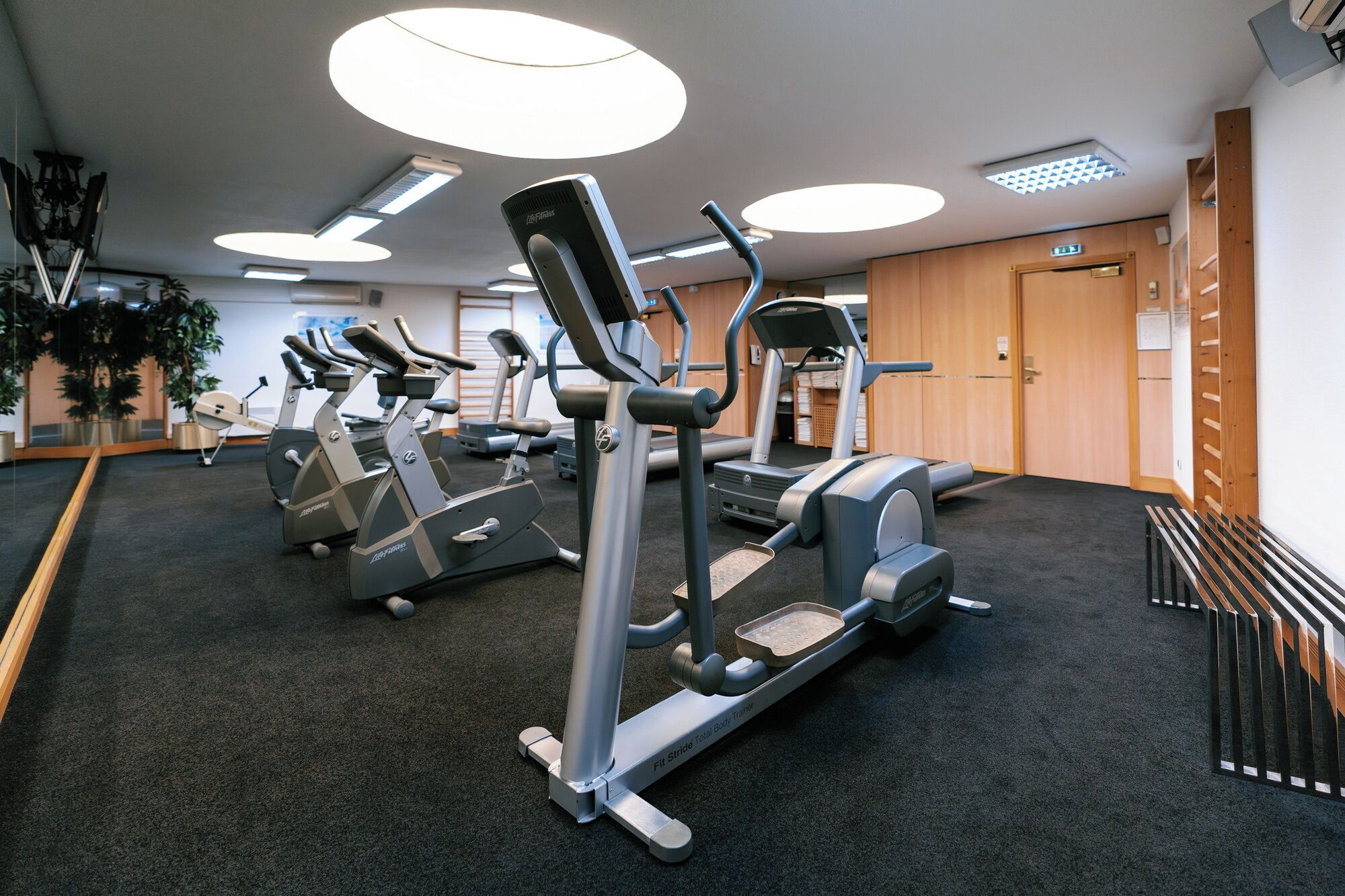 Una palestra con macchinari cardio, una pista per camminare e un'area dedicata ai pesi.