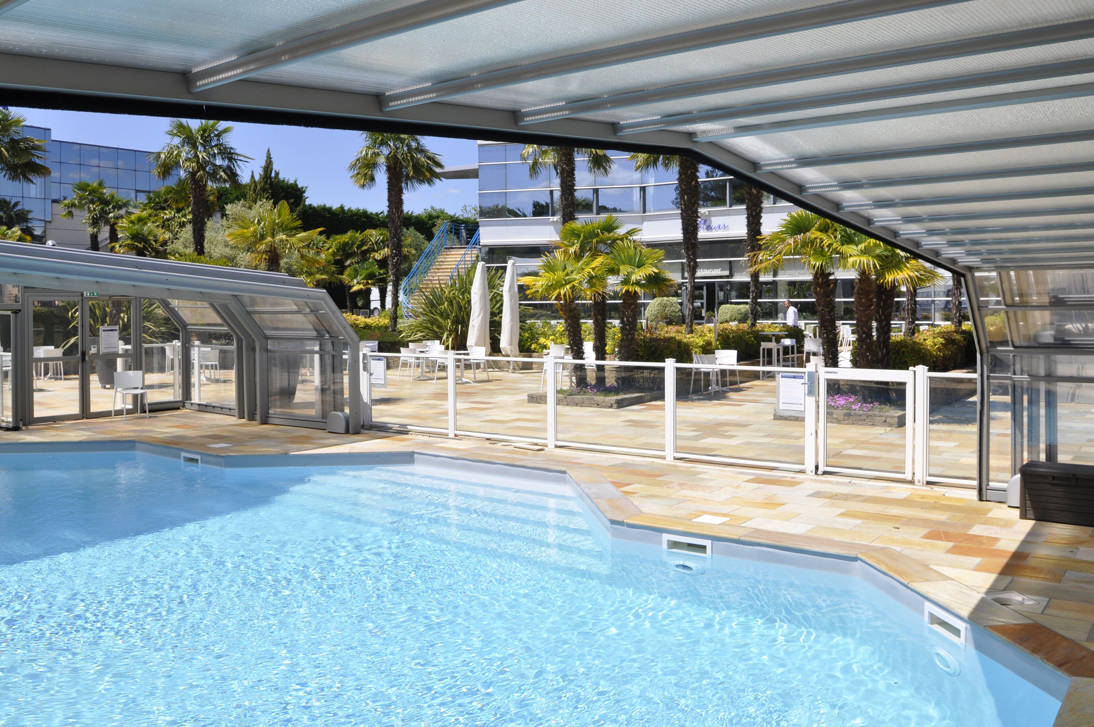 Seasonal outdoor pool, open 10:00 AM to 10:00 PM, pool umbrellas