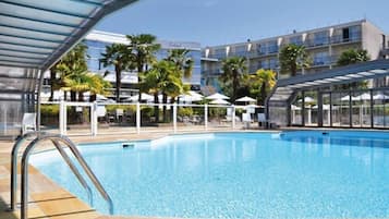 Seasonal outdoor pool, open 10:00 AM to 10:00 PM, pool umbrellas