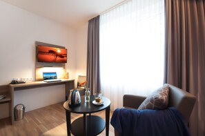 Hypo-allergenic bedding, desk, laptop workspace, blackout drapes