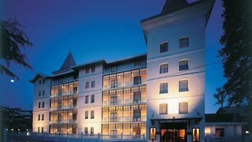 Stunning hotel with a classic facade, featuring evenly spaced windows and balconies.