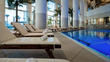 A pool area with lounge chairs and a clear view of the pool.