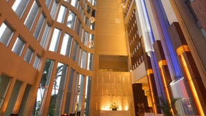 A spacious lobby with high ceilings, large windows, and modern lighting fixtures. - Hilton Colon Guayaquil (Guayaquil)