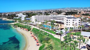 Un complexe hôtelier doté d’une piscine, d’une plage et offrant une vue sur l’océan.
