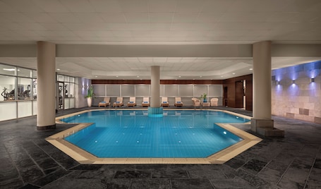 Indoor pool, outdoor pool, pool umbrellas, sun loungers. Mediterranean Beach Hotel