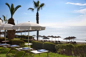 On the beach, sun-loungers, beach umbrellas, beach towels
