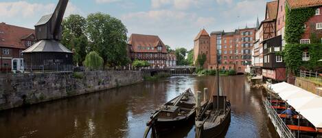 A river with boats, historic buildings, and a bridge.