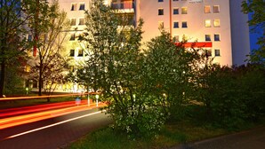 A multi-story hotel with balconies, a prominent sign reading "ENJOY HOTEL," and a well-lit facade. - Enjoy Hotel Berlin City Messe (Berlin)