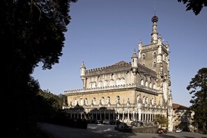 A historic building with ornate architecture, featuring multiple towers and arched windows. - Bussaco Palace Hotel (Mealhada)