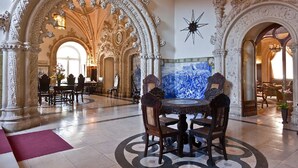 An ornate hall with high ceilings, intricate moldings, and a large, ornate chandelier. - Bussaco Palace Hotel (Mealhada)