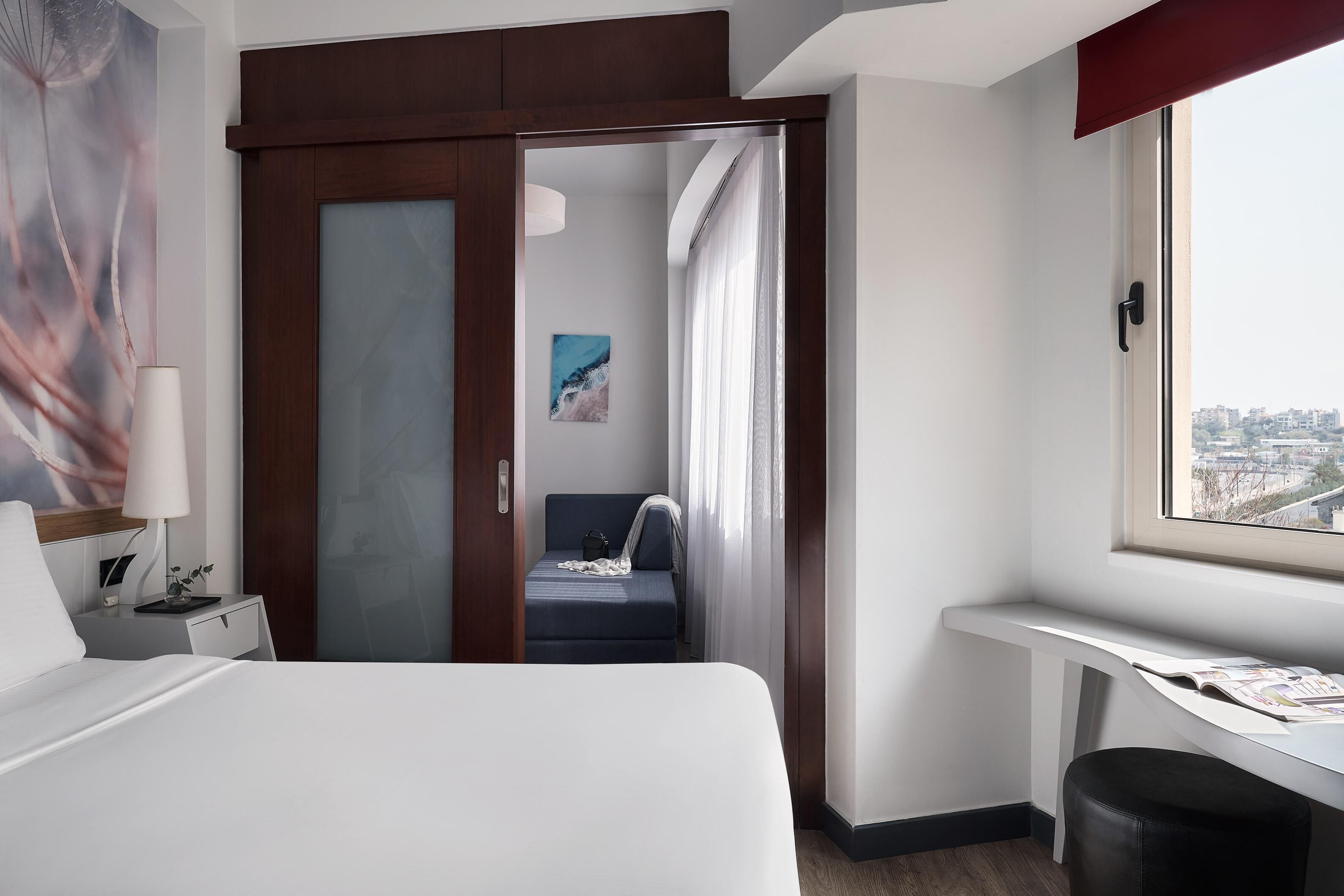 Superior Triple Room, City View | Minibar, in-room safe, laptop workspace, soundproofing