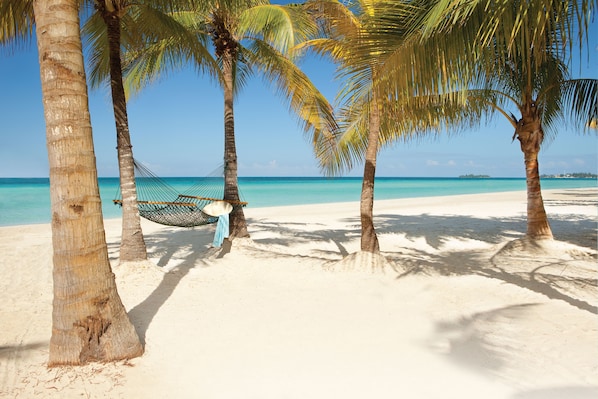 On the beach, white sand, sun loungers, beach towels - Couples Swept Away All Inclusive (Negril)