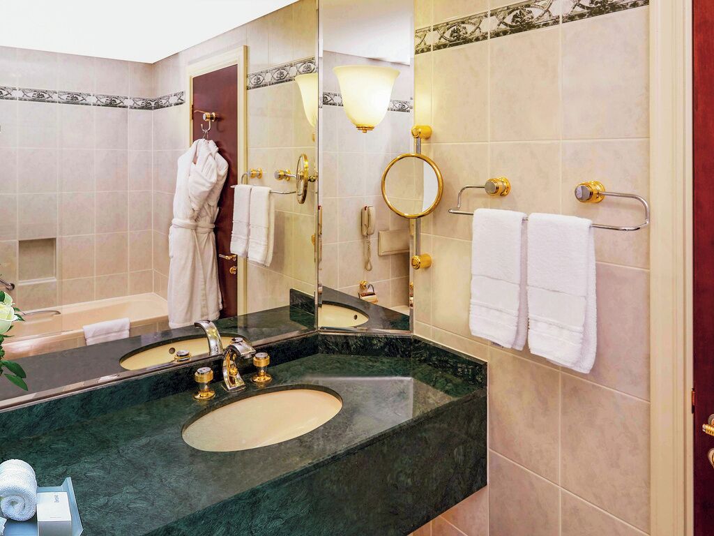 bathtub, eco-friendly toiletries, hair dryer, slippers