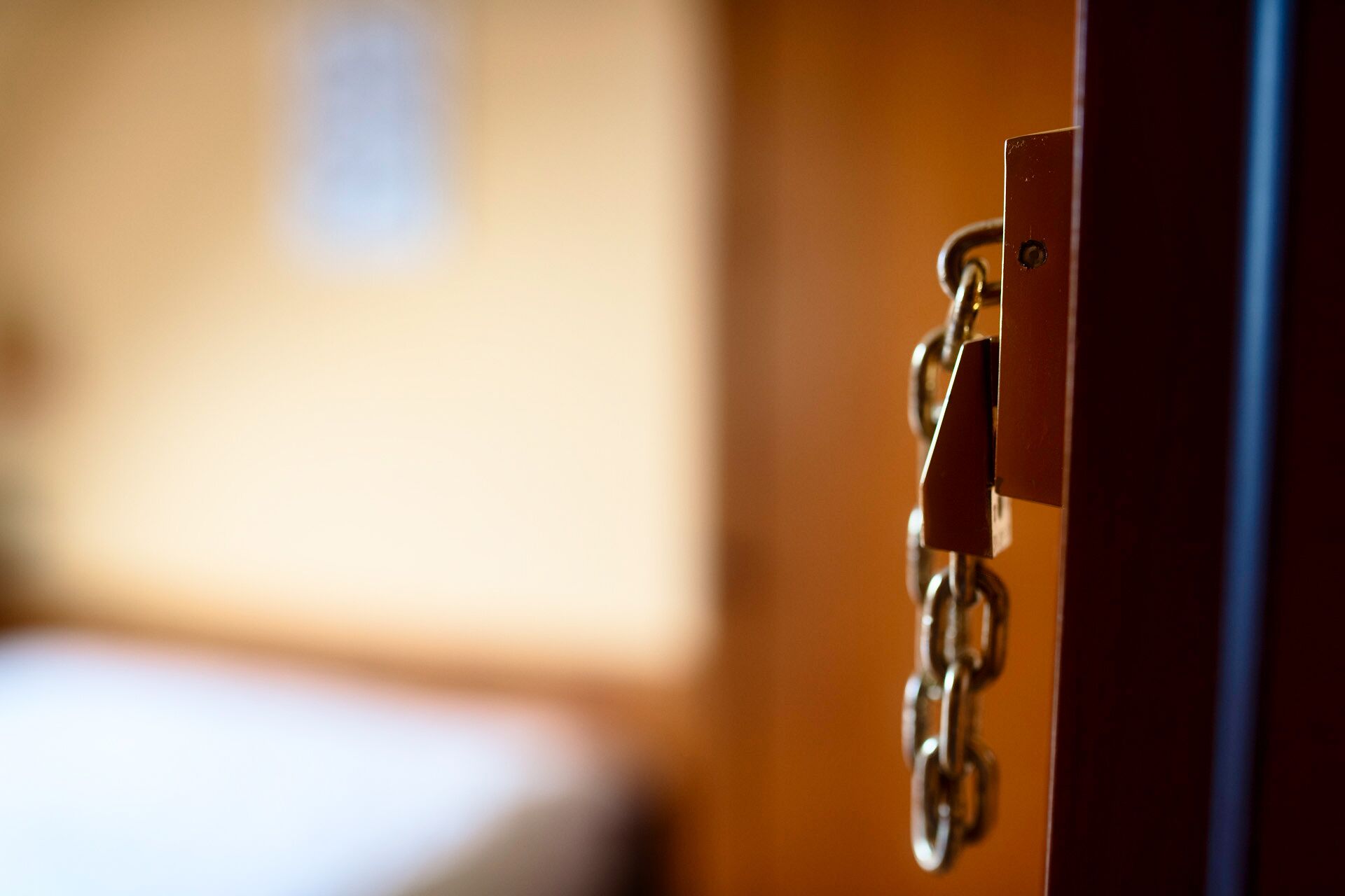 A close-up of a door latch with a chain.
