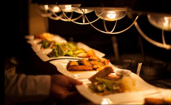 A row of plated dishes with various appetizers and salads, likely in a restaurant setting. - Cabo Surf Hotel & Spa (San José del Cabo)