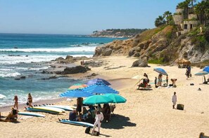 On the beach, white sand, sun loungers, beach umbrellas
