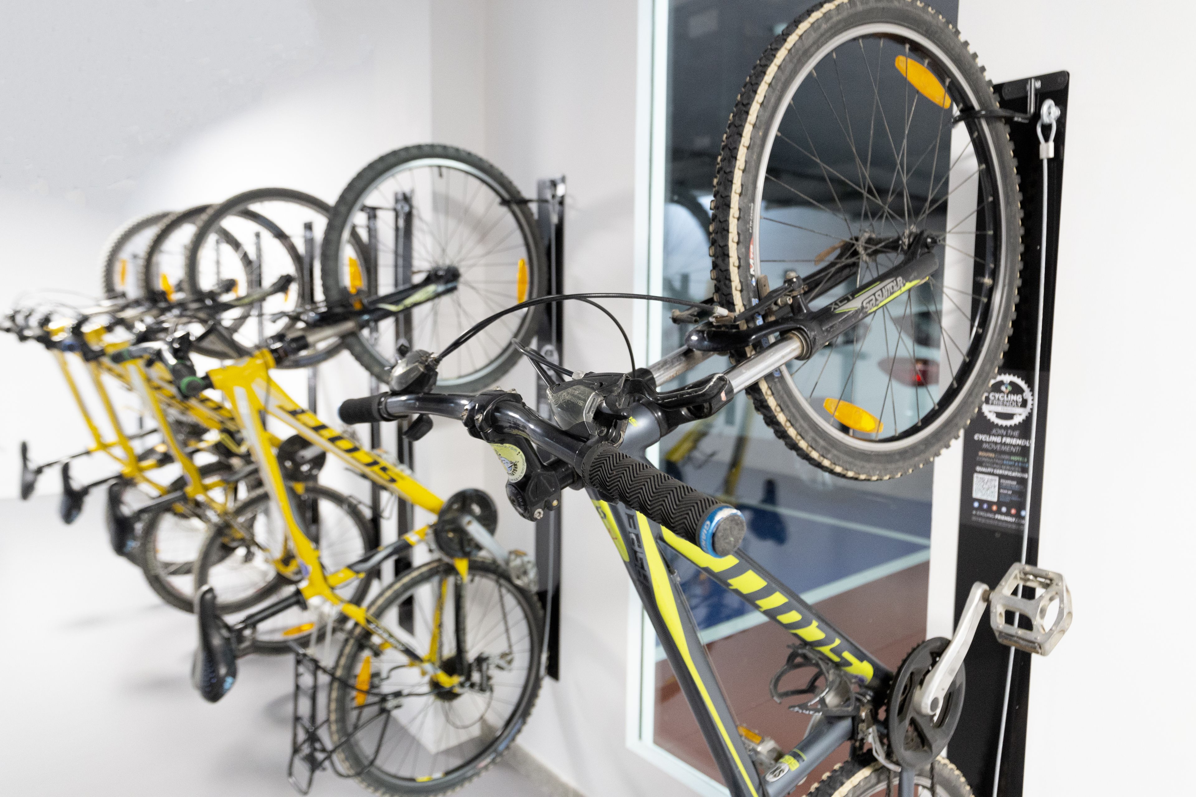 A bike rack with multiple bicycles.