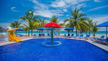 Relax by the pool surrounded by palm trees and a soothing fountain.