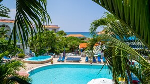 A pool area with lounge chairs and a view of the ocean. - Franklyn D. Resort & Spa (Runaway Bay)