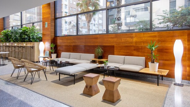 A modern lobby with a seating area, large windows, and indoor plants. - Hotel Eurostars Acteón (Valencia)
