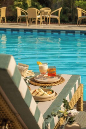 Seasonal outdoor pool, open 9:00 AM to 7:00 PM, pool loungers