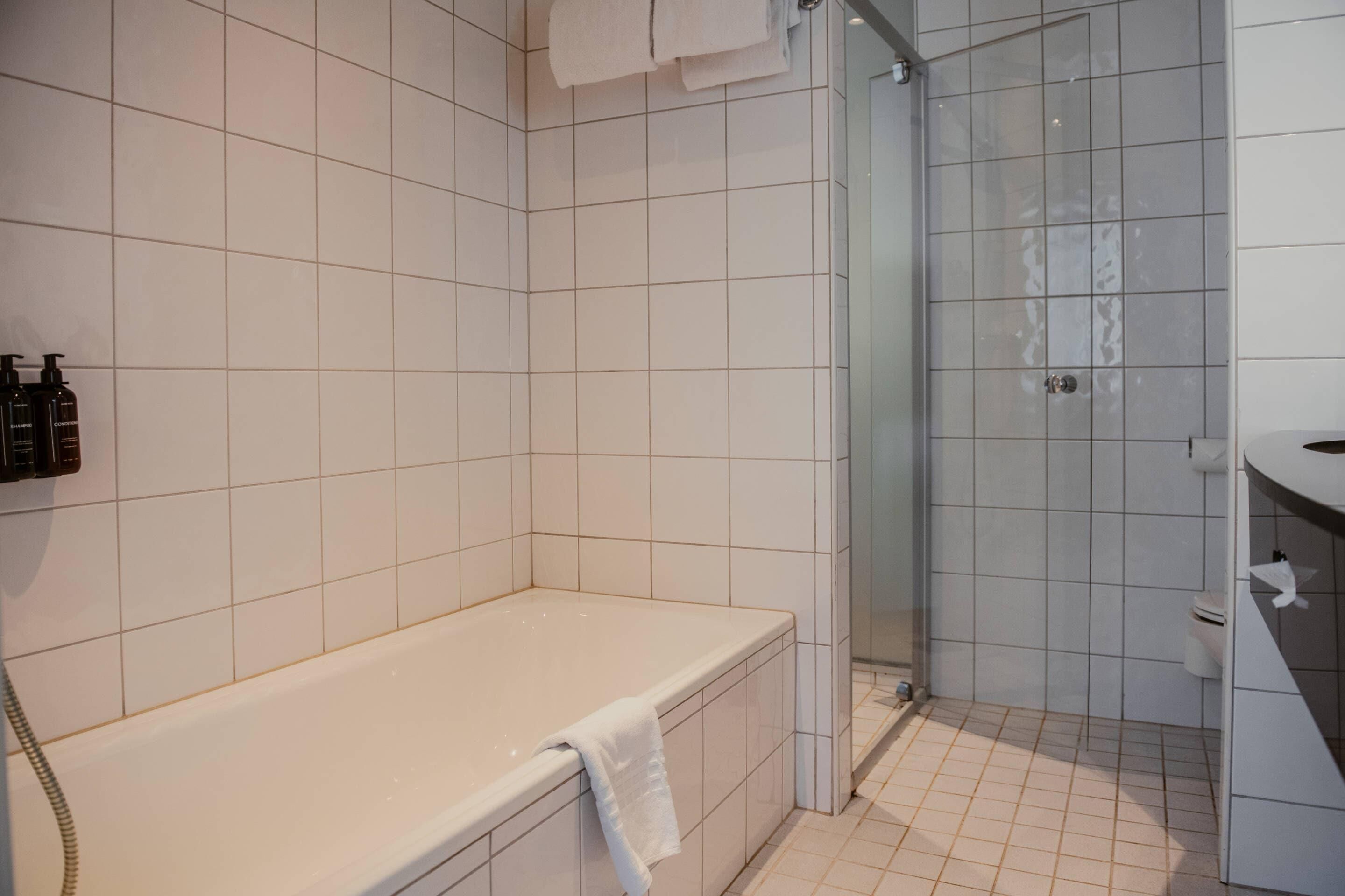 A bathroom with a bathtub, a shower, and a toilet.