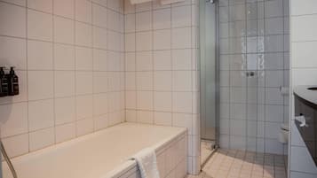 A bathroom with a bathtub, a shower, and a toilet.