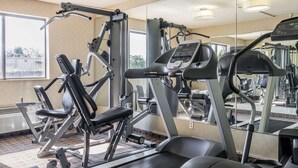 A gym with various exercise machines, a mirrored wall, and large windows. - Comfort Inn Nashville West (Nashville)