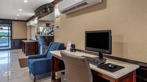 A hotel reception area with a desk, computer, and seating. - Comfort Inn Nashville West (Nashville)