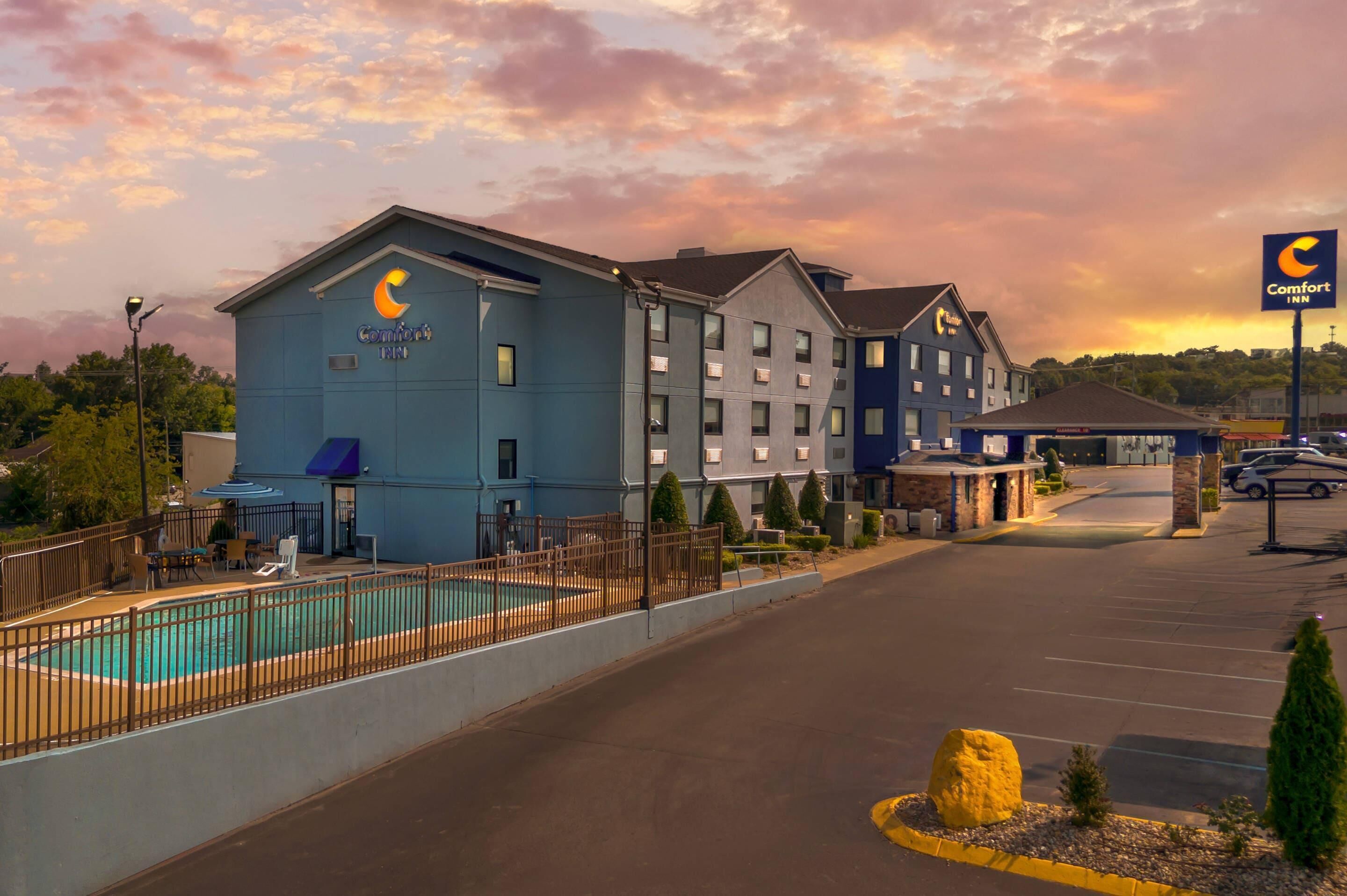 A Comfort Inn hotel with a swimming pool, multiple buildings, and a parking lot.
